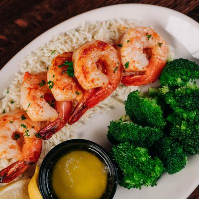 Broiled shrimp with broccoli, rice, and butter sauce.