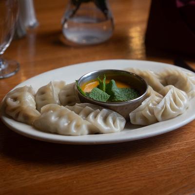 Chicken momo dumplings served with homemade sesame seed sauce.