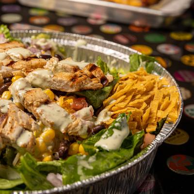 Salad of grilled chicken, tomato, corn, red onion, black beans, cheese, avocado, tortilla strips