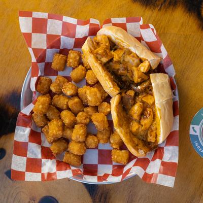 The Archie Chicken Sandwich served with a side of tater tots.
