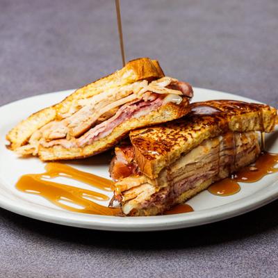 Monte Cristo sandwich drizzled with syrup and served.