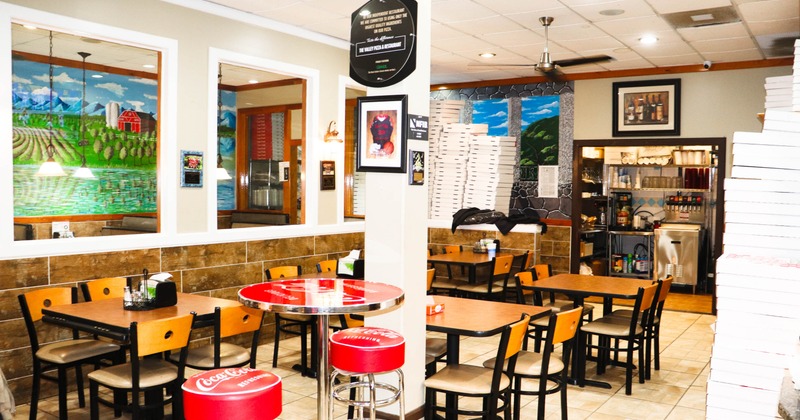 Interior, dining area, wooden tables, chairs, Coca-Cola stools, rural landscape mural
