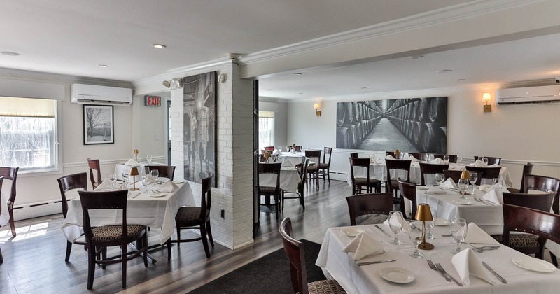 Interior, dining area, set-up white cloth tables, white brick walls, tile flooring