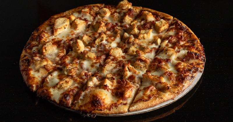 Chicken bacon ranch pizza on a round tray