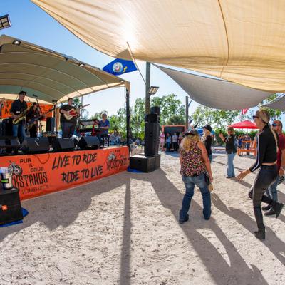 A live music performance outside and people dancing.