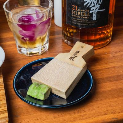 Block of fresh wasabi root served with a wasabi grater.