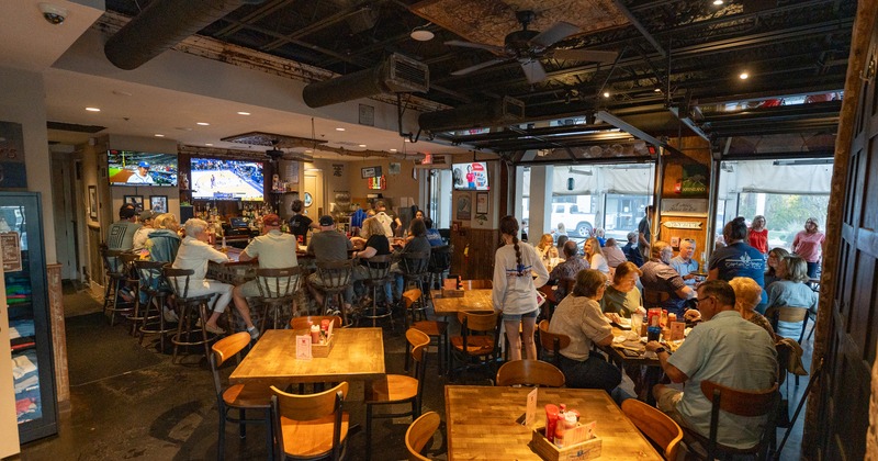 Cozy interior bar and seating area full of guests