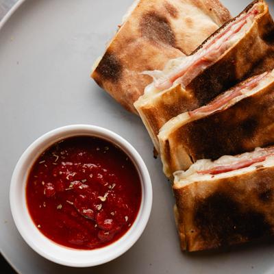 Sliced stromboli with marinara sauce.