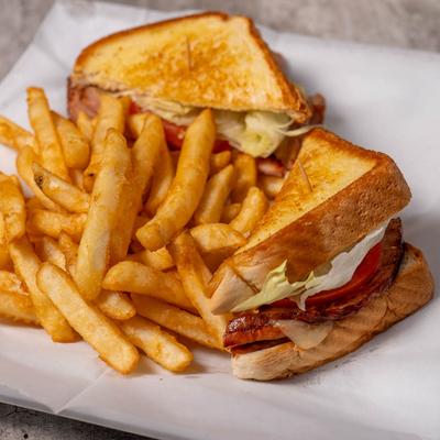 Club sandwich with fries.