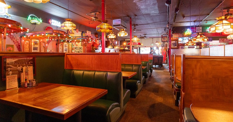 Cozy dining area with comfortable upholstered booths and  wooden tables