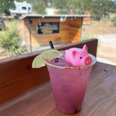 Pink cocktail with a pig squeaky toy.