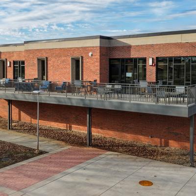 Restaurant's building featuring an elevated outdoor patio terrace with seating.