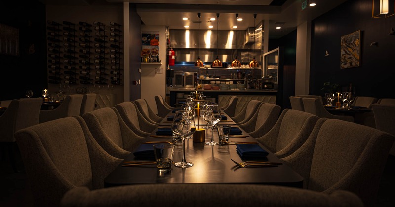 Long dining table set with candles and glassware