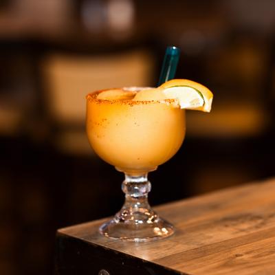 Frozen Margarita sits on a wooden table.