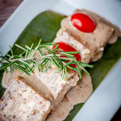 Spiced grilled cubes of homemade cheese with rosemary, olive paste, and cherry tomatoes.