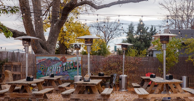 Exterior, seating area, tables, benches, lights, lanterns, trees, the sky