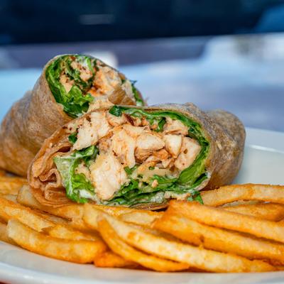 Chicken Caesar Wrap served with fries.