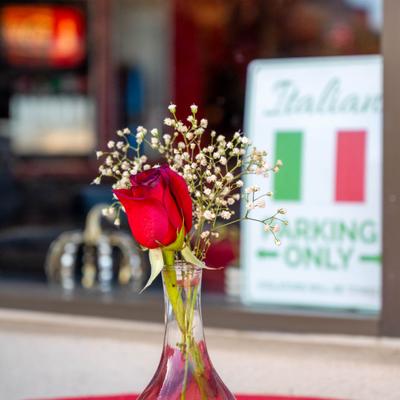 Red Rose and Baby Breath flowers in a vase.