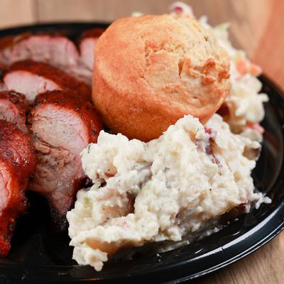 Grilled sliced meat and pastry, salad on the side