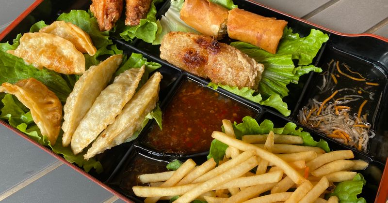 A platter with dumplings and egg rolls
