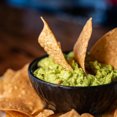 Guacamole and chips, close up.