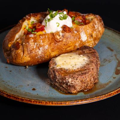 Filet mignon with a loaded baked potato.