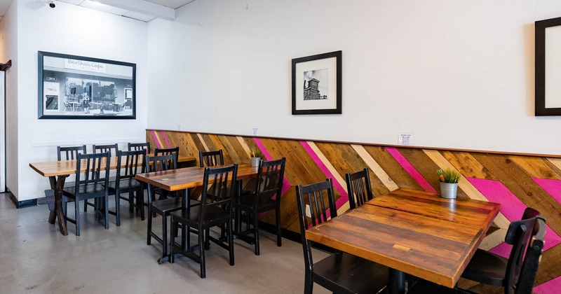 Interior, tables ready for guests, pictures on the walls