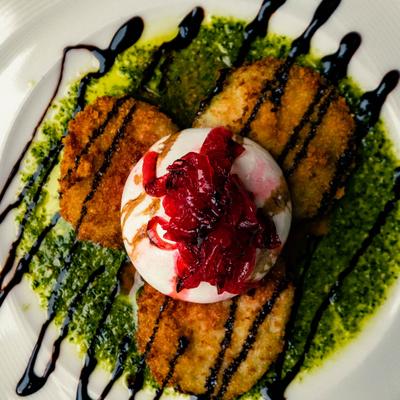 Fried Green Tomatoes topped with burrata cheese, glaze and