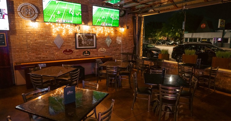 Sitting area with two large TV screens on the wall