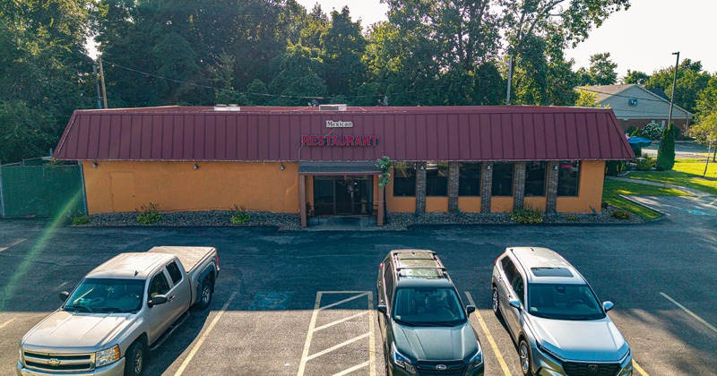 Exterior, aerial view to restaurant parking lot and front lawn