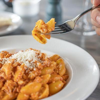 Conchiglie a Modo Mio - Shells in a pink sauce with chicken, pork, Genoa salami, Ricotta, and aged Gruyere cheese.