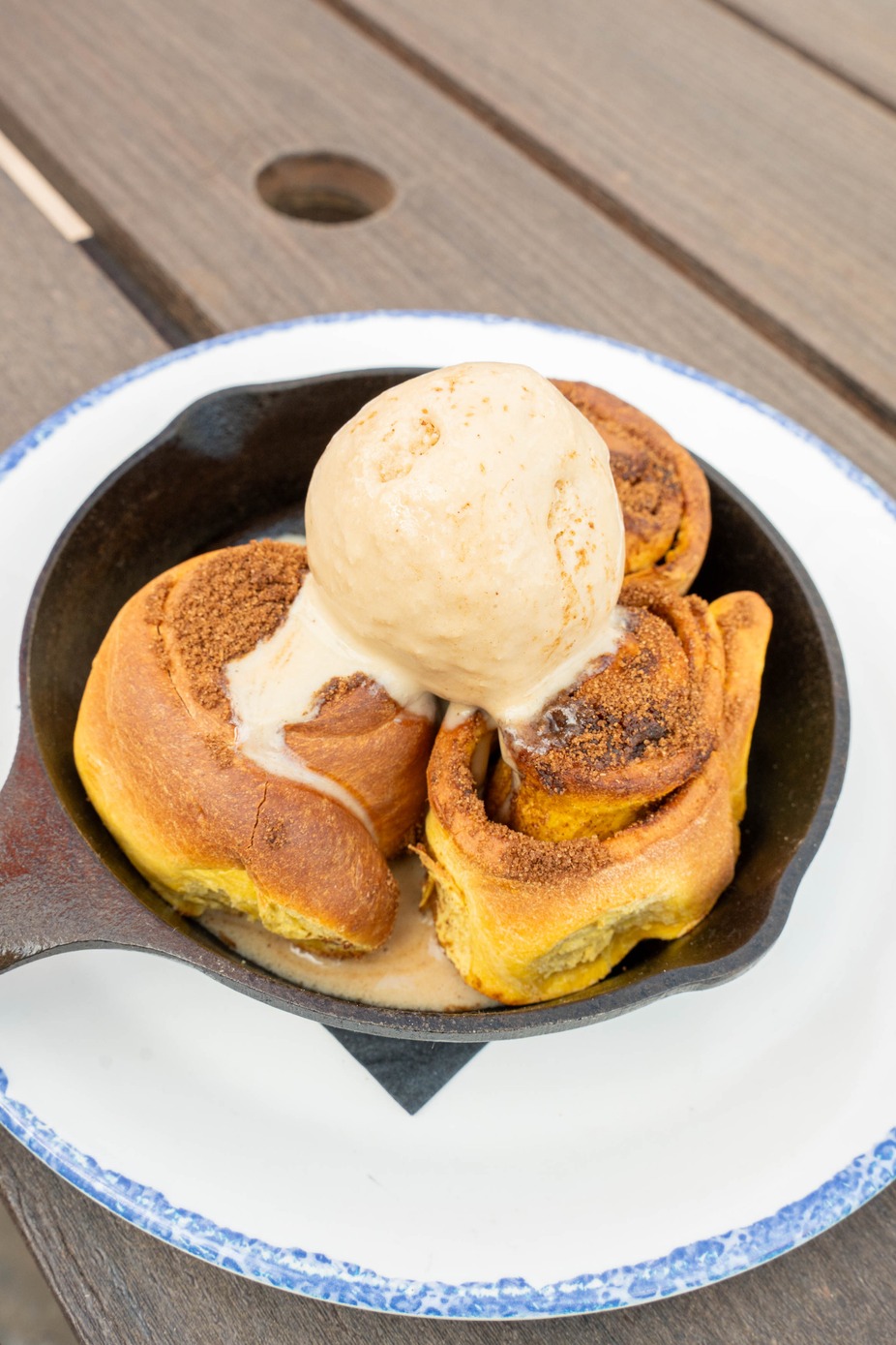 Pumpkin spice cinnamon roll skillet topped with Biscoff ice cream