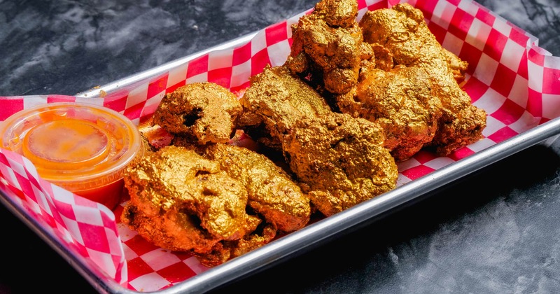 Fried chicken smothered in gold colored sauce
