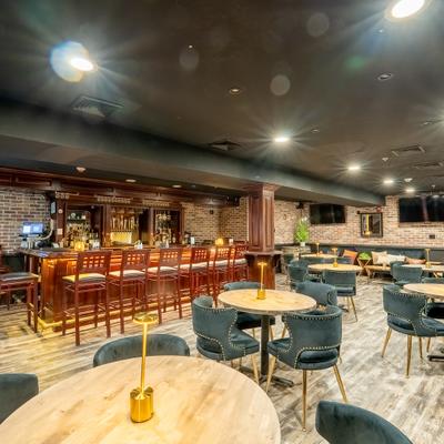 The Double z Bourbon Lounge stained wooden bar and tables.
