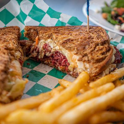 Reuben sandwich served  with  fries