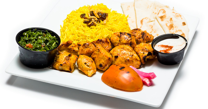 Grilled meat, green salad, white dip, rice on the side