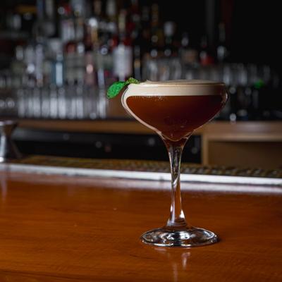 Samurai sour cocktail rests on a bar counter.