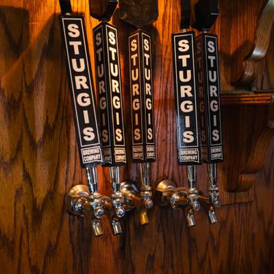 Beer taps behind the bar, close-up.