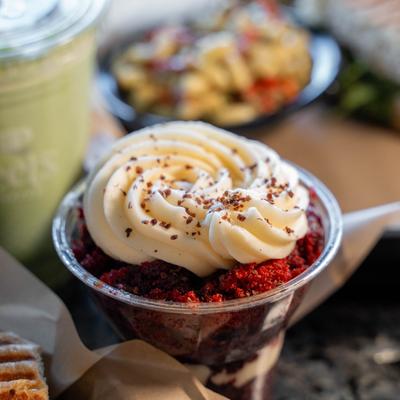 Red velvet parfait with swirled cream topping.