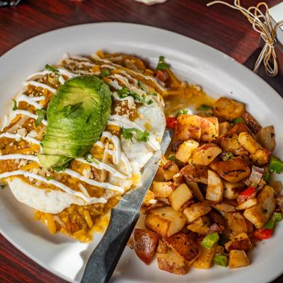 Smothered breakfast omelet served with seasoned potatoes.