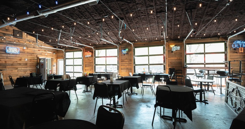 Interior, wide shot of dining area with large windows in the background