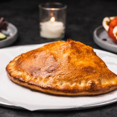 Calzone served on a white plate.