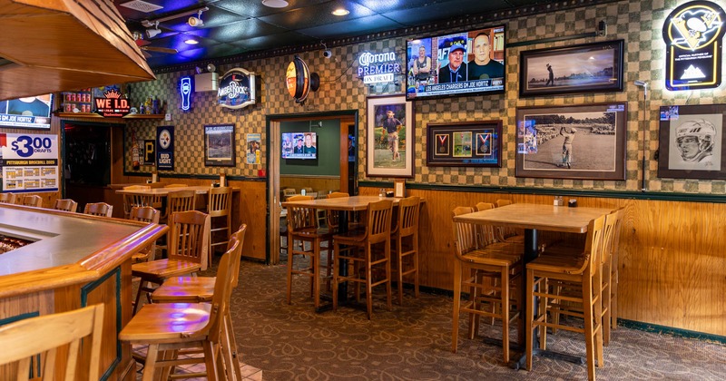 Interior bar area, seating, wall TV and wall decor