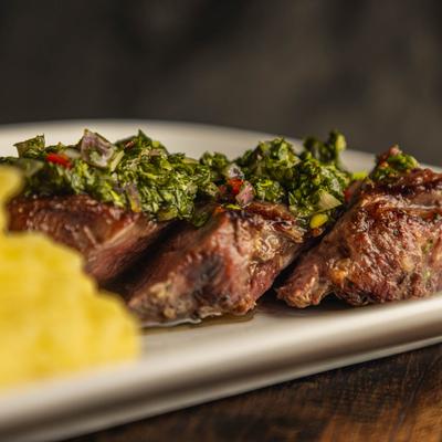 Grilled steak with chimichurri sauce.