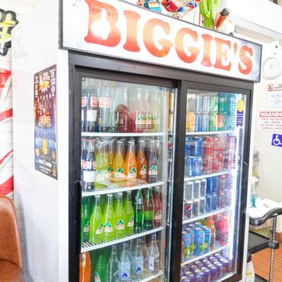 Refrigerator filled with assorted sodas.