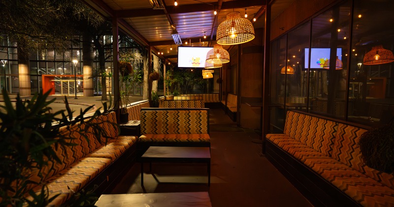 Booths, coffee table, seating place, tv screen above