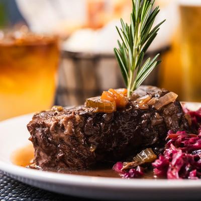 Marinated steak and braised red cabbage, served.