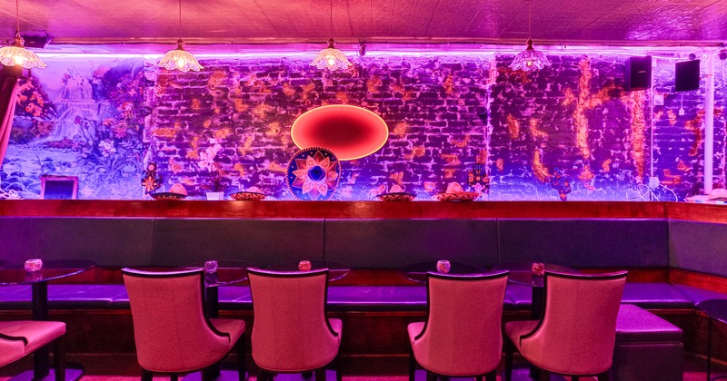 Interior, booth, table, armchairs, light decorated wall behind