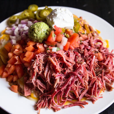 Irish Nachos. A heap of corned beef, tomatoes, red onion, jalapenos, sour cream, guacamole and pico de gallo