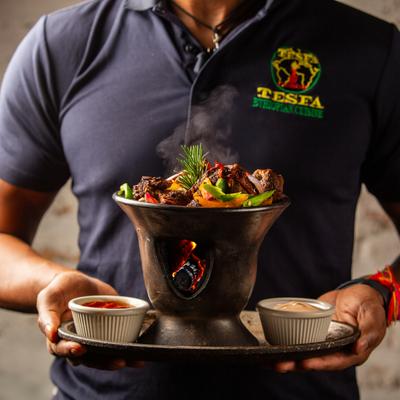 A person carrying a tray with food.